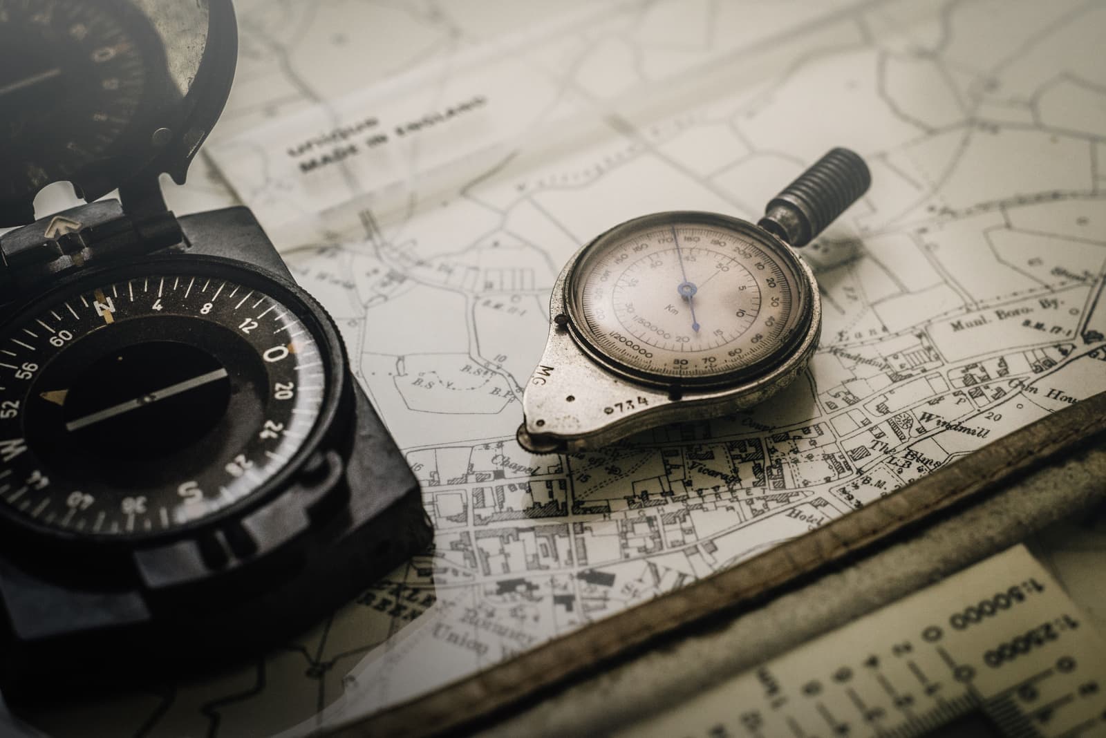 Compass and map measurer resting on a printed topographic map